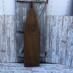 an old wooden board leaning against a wall