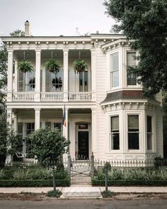 a large white house with many windows and balconies