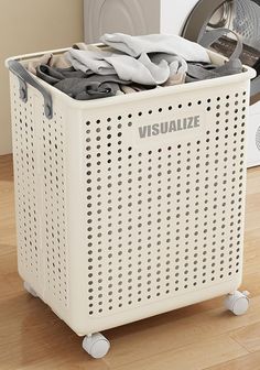 a white laundry basket with clothes in it