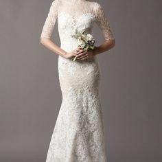 a woman in a wedding dress holding a bouquet