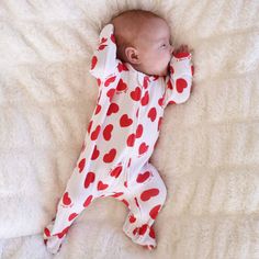 Wrap your little love in a bundle of softness with our XOXO Waffle Zipper Footie! Made from ultra-soft bamboo waffle fabric, this lightweight footie is as comfy as a warm hug and perfect for cozy cuddles. This sweet design is sprinkled with red hearts and the words "I love you," making it the perfect outfit for celebrating the most lovable day of the year. Whether it’s a cuddle session at home or their first Valentine’s Day photoshoot, this footie is sure to melt everyone's heart this Valentine's Day season.   One-Piece Footie Details: 95% Bamboo Viscose | 5% Spandex Footed One-Piece with Zipper and Grips  Double-zipper style for easy diaper changes True-to-size Includes: 1 Zipper Footie (Accessories sold separately) Care Instructions: Machine Wash Cold - Gentle Cycle  Phosphate Free Deter Hanukkah For Kids, Cozy Cuddles, Personalized Swaddle, Girls Nightgown, Newborn Accessories, Hooded Bath Towels, Sibling Shirts, Waffle Fabric, Kids Blankets