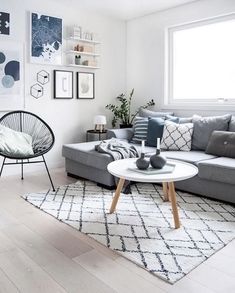 a living room filled with furniture and pictures on the wall