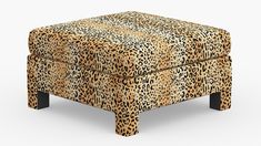 a leopard print footstool with black legs and an animal print upholster