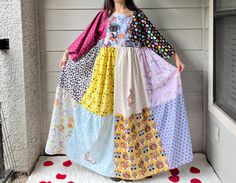 a woman in a colorful dress standing on a porch