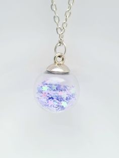 These pretty glass necklace, sparkle pendant, in a variety of colours, would make a fantastic present for birthday gift for mother, daughter, neice or gift for her.  Why not treat yourself to a self gift. sale. These confetti bauble pendants are filled with glitter, crystals or stars with silver plated finish. The colours available are pink, dark pink, green, purple, gold, multicolored, silver, orange and lilac. The necklace length is 16 or 18 inches silver plated. The following items cannot be Purple Glitter Jewelry For Gifts, Purple Glitter Jewelry Gift, Sparkling Purple Jewelry Gift, Sparkling Purple Jewelry For Gift, Iridescent Sparkling Jewelry As Gift, Iridescent Sparkling Jewelry Gift, Sparkling Iridescent Jewelry As Gift, Sparkling Iridescent Jewelry For Gifts, Sparkling Round Pendant Necklace As Gift