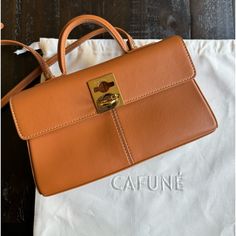 Cafune Stance Wallet Color: Chestnut Detachable/ Adjustable Strap 100% Authentic. Purchased From Cafune Website. In Gently Used Condition Comes With Dust Bag And All Original Packing Cards & Tissue Paper. Can Also Send Receipt Upon Request. From Website: Details Premium Italian Cow Leather Signature C-Lock Clasp Lock Detachable Adjustable Shoulder Strap Internal And Back Zip Pockets Internal Bill And Card Slots Black Recycled Polyester Lining Gold Hardware Currently Retailing For $448+ Tax On Website. Open To Resonable Offers Luxury Brown Wallets For Office, Luxury Brown Wallets, Chic Brown Crossbody Wallet, Brown Rectangular Wallet With Detachable Strap, Brown Wallet With Detachable Strap, Brown Wallet With Detachable Strap For Everyday, Brown Wallets With Detachable Strap, Chic Everyday Brown Wallet, Brown Wallet With Gold-tone Hardware For Daily Use