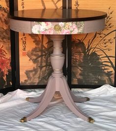 a round table with flowers painted on it