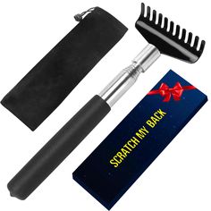 a hair brush and comb next to a gift box with a red bow on it