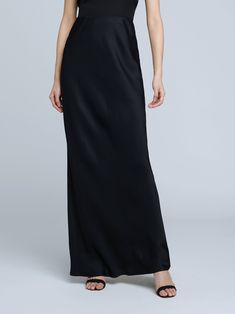 A stunning, understated maxi skirt in pure black. Bias-cut, silk-like fabric falls in a subtle, lustrous cling over the figure, enhancing and elongating the silhouette. Smooth elastic waist with no closures. Sleek Black Satin Finish Maxi Dress, Full Length Satin Finish Maxi Dress, Sleek Full-length Bias-cut Maxi Dress, Black Satin Full-length Maxi Dress, Sleek Solid Color Maxi Dress For Formal Occasions, Elegant Maxi Skirt For Night Out, Elegant Black Bottoms With Satin Finish, Sleek Silk Evening Bottoms, Black Evening Skirt With Side Slits