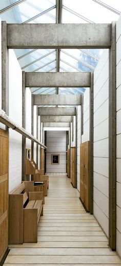 an empty hallway with several wooden boxes on the floor