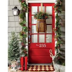 a red front door decorated with christmas decorations