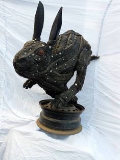 a statue of a rabbit on top of a pot