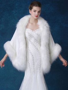 a woman in a white dress and fur coat