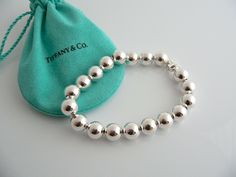 Overview:Offered for sale is a wonderful Tiffany classic. Whether you are just starting your Tiffany collection or are thinking of adding another piece, this one is perfect for you. Tiffany & Co.'s Sterling 19 Ball / Bead bracelet is a Tiffany classic that will never go out of style. The piece makes a statement in its own subtle/simple way. It will most certainly be a piece that you will turn to over and over again, making it great value for your money. It is a wonderful bracelet that fits a Luxury Hand-strung Silver Jewelry, Luxury Sterling Silver Beaded Bracelets, Classic Sterling Silver Bracelet With Polished Beads, Classic Silver Beaded Bracelet Gift, Luxury Sterling Silver Round Bead Bracelets, Classic Silver Beads Bracelet Gift, Classic Sterling Silver Bracelet With Polished Beads As Gift, Classic Silver Beads Bracelet As A Gift, Elegant Hand-strung Sterling Silver Bracelet