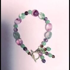 This Is A Gorgeous New Artisan Crafted 6” Pastel Green And Purple Glass Beaded Bracelet With Toggle Clasp! You Can Make A Fashion Statement In Perfect Style! You’re Going To Get Lots Of Compliments! Comes Already Gift Wrapped And In A Fancy Gold Gift Box! Makes An Excellent Gift For Yourself Or Your Loved Ones! Comes From A Smoke And Pet Free Environment. Please Ask Any Questions You Have. Offers Welcome! Thank You For Shopping With Us At Nancy’s Creative Treasures! Handmade Adjustable Lavender Crystal Bracelet, Adjustable Handmade Lavender Crystal Bracelet, Adjustable Multicolor Amethyst Bracelet, Adjustable Multicolor Amethyst Bracelets, Handmade Multicolor Amethyst Bracelets, Adjustable Green Amethyst Jewelry, Adjustable Purple Beaded Bracelets With Lobster Clasp, Pastel Green And Purple, Glass Beaded Bracelet