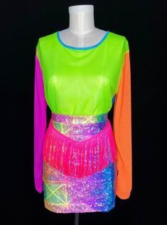 Rainbow tie dye printed spandex mini skirt with neon pink fringe top stitched to the front waist. Runs true to size. Form wearing size Small. Message us with any sizing questions! Size Guide: XS > 0-2 S > 4-6 M > 6-8 L > 10-12 XL > 14-16 Made in 80% Nylon 20% Spandex Hand soak in cold water. Line dry. Female owned business, SLOW FASHION. Follow us on Instagram @messqueen_newyork ! Handmade to order in Brooklyn <3 Fitted Multicolor Skort For Party, Multicolor Mini Skort For Party, Party Mini Skort In Multicolor, Multicolor Skort For Party, Party Multicolor Mini Skort, Pink Fringe Top, Cowboy Fringe, Pink Silk Skirt, Burning Man Clothing