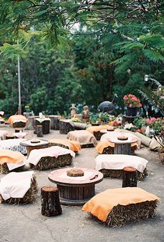 an image of outdoor seating made out of hay bales and covered with orange covers