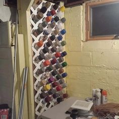 a room with a table and some paint cans on the wall next to a window