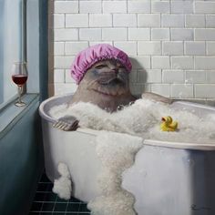 a seal in a bathtub with bubbles and a rubber duck