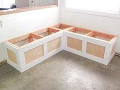 an unfinished kitchen counter is being built in the middle of a room with white walls