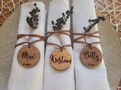 three napkins wrapped in twine and tied together with wooden tags that say, mr and mrs