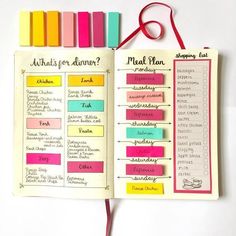 an open planner with colorful sticky notes attached to the pages and a red string hanging from it