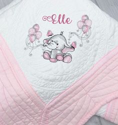 a pink and white blanket with an elephant on it