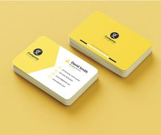 two yellow business cards sitting on top of each other next to an orange and yellow background