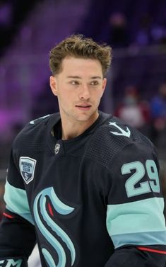 a hockey player is looking at the camera