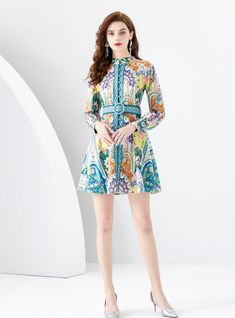 "Beckoning the eye with its kaleidoscope of vibrant colors, this striking dress is a masterpiece of print and pattern. Evoking the intricate designs of Moroccan tiles, each swirl and floral motif bursts with life, setting a tone of exuberant elegance. The dress, with its neat mandarin collar and delicate button-down front, cinches at the waist with a bold, patterned belt, crafting a silhouette that's as flattering as it is playful. Full-length sleeves culminate in neat cuffs, making this dress a trans-seasonal gem. This is a dress designed not just to be worn, but to be paraded; a statement piece for the bold fashionista ready to captivate at any daytime soiree or evening event." Pattern: printingSkirt length: short Skirt type: flounce skirtCollar type: high collarSleeve length: long sleev Print And Pattern, Printed Short Dresses, Sleeveless Dresses Casual, Flounce Skirt, Office Chic, Moroccan Tiles, Pink Midi Dress, White Maxi, Maxi Dress Party