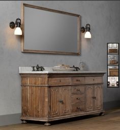 a bathroom vanity with a mirror above it and two lights on the wall next to it