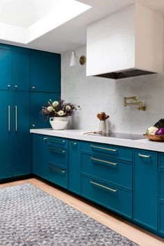 a kitchen with blue cabinets and white counter tops is featured in an ad for the new york times