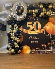 a 50th birthday backdrop with balloons and streamers