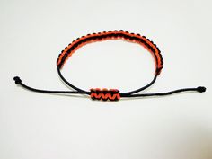 ------- Other Colors are available upon request--------- Micro paracord bracelet made from micro paracord It is made with black and orange colors This bracelet is fully adjustable and is easy to take on and off If purchasing please leave a tight measurement of your wrist in the comments of your order and we will add the appropriate amount of extra paracord to make your bracelet fit well Adjustable Black Braided Bracelet For Outdoor, Unique Orange Adjustable Bracelet, Playful Adjustable Orange Bracelets, Duck Call Lanyard, Handmade Black Paracord Braided Bracelet, Orange Spiritual Stretch Bracelet Hand-strung, Casual Black Paracord Bracelet, Adjustable Black Paracord Braided Bracelet, Adjustable Nickel-free Orange Bracelets