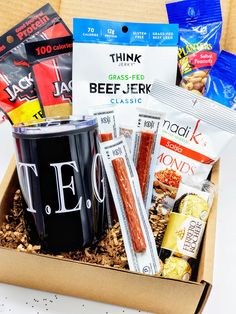 a box filled with snacks and drinks on top of a table