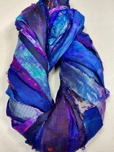 a purple and blue scarf on a white surface