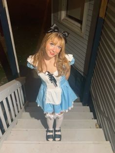 a woman dressed up as alice mouse on the steps