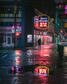 a person walking down the street at night