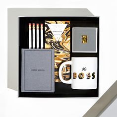 the boss gift set includes two mugs, notebook and pencils in a black box