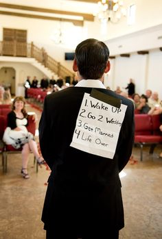 a man in a suit with a sign on his back