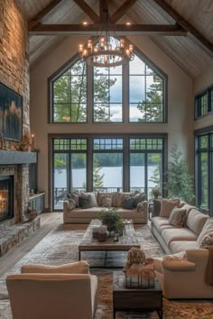 a living room filled with lots of furniture and a fire place in front of a large window