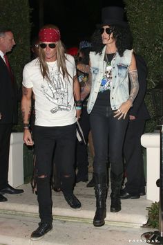 two people dressed in black and white standing on steps