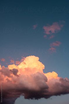 the sky is filled with pink clouds as the sun goes down in the distance by jordir for stocks