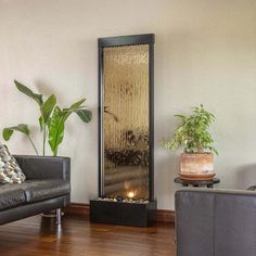 a living room filled with furniture and a water fountain in the middle of the floor