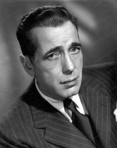 an old black and white photo of a man in a pinstripe suit with a tie