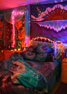 a bed room with a neatly made bed and colorful wall hangings on the walls