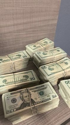 stacks of money sitting on top of a wooden table