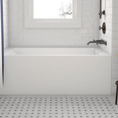 a white bath tub sitting next to a window