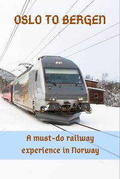 a train is traveling down the tracks in the snow