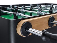 a foosball table is shown with black and wood accents on the back side